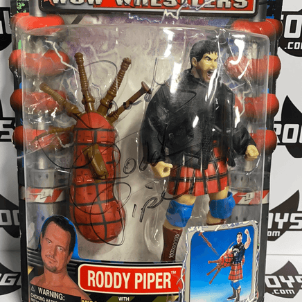 ToyBiz Power Slam WCW Wrestlers Roddy Piper with Missile Firing Bag Pipes and Hammer Punching Action Autographed - Rogue Toys